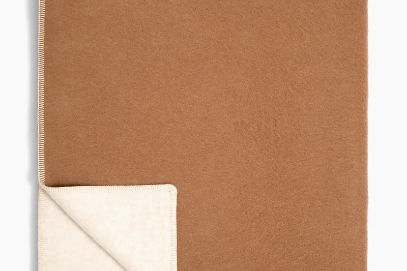 Twin blanket folded to show its ivory reverse